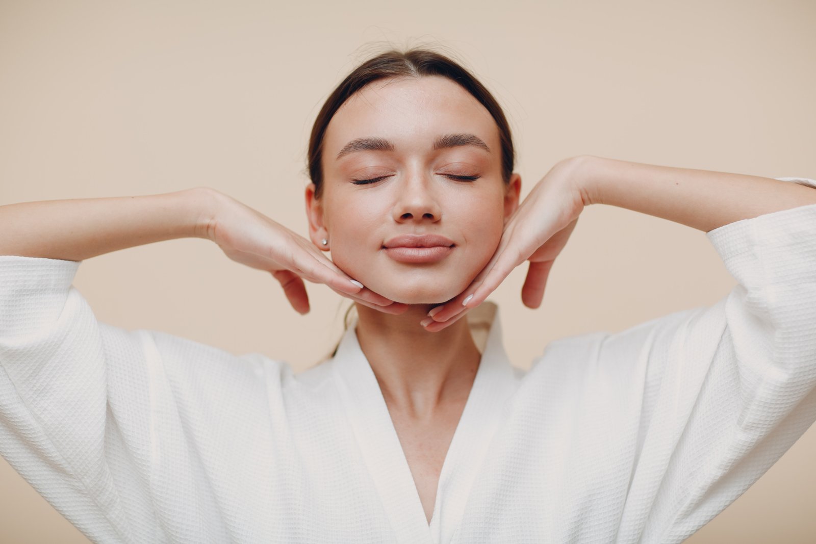 Woman practising a Face Yoga jawline movement